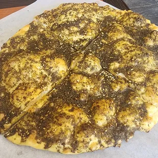 Arab Zaater which is it combination of oragano, thyme, sesame seed, and olive oil all mixed together and baked.