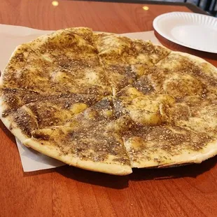 Manakeesh, a mixture of thyme, oregano, sesame seed, and other herbs all mixed with olive oil before being baked.