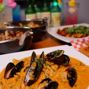 a plate of mussels in a creamy sauce