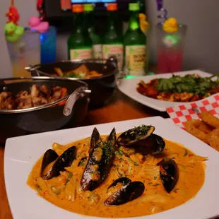 a plate of mussels and other foods on a table