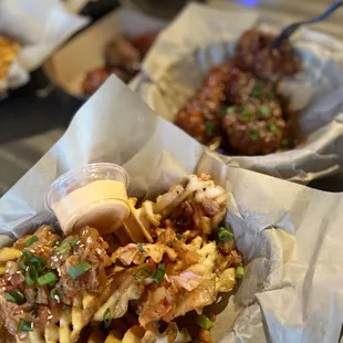 Kimchi waffle fries, chicken tenders in background