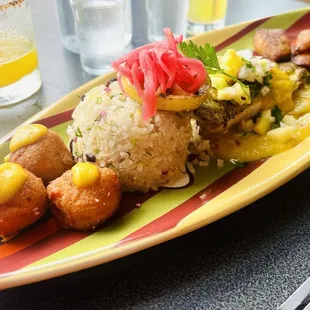 Pescado Caribeño: Red Snapper Filet with coconut rice, sweet plantain, sweet potato croquettes, citrus pineapple glaze, and pineapple pico.