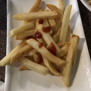 a plate of french fries with ketchup