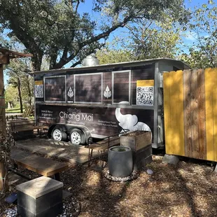 a food truck parked in a wooded area
