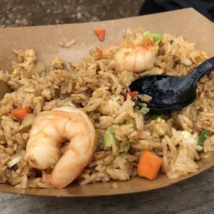 shrimp fried rice in a paper bowl