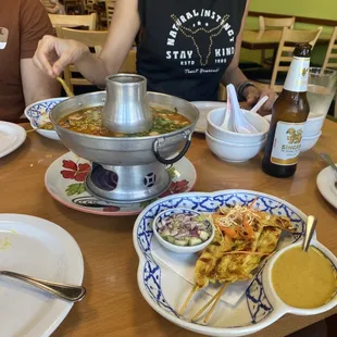 woman sitting at a table with plates of food
