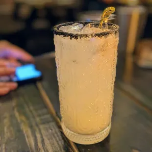 a cocktail with a lemon garnish