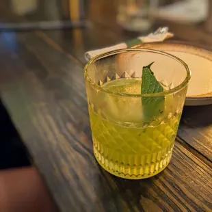 a glass of lemonade on a table