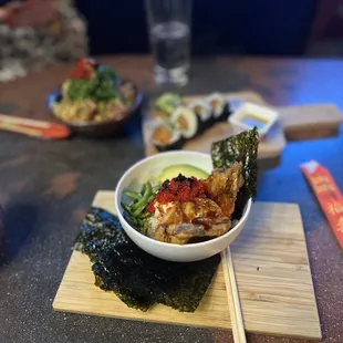 a bowl of sushi and chopsticks