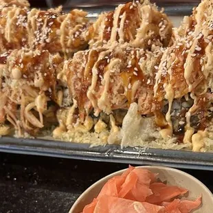 a plate of sushi and a bowl of salmon