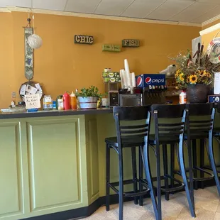 a restaurant counter with four stools
