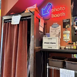 a photo booth with a neon sign