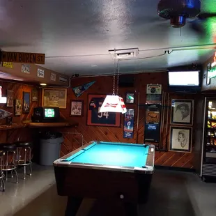 a pool table in the middle of the room