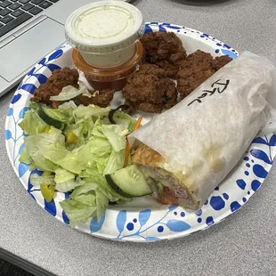 a burrito and salad on a plate