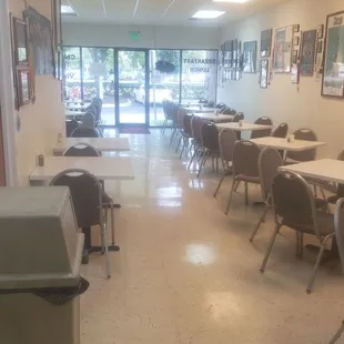 a cafeteria with tables and chairs