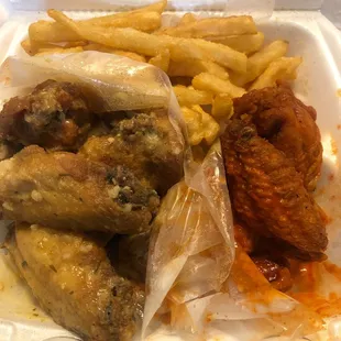 chicken wings and fries in a styrofoam container