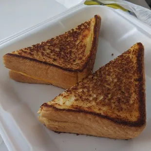 two sandwiches in a styrofoam container