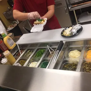 Making the Chicago style hotdog