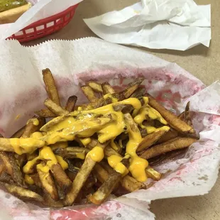Cheese fries with cheese on top instead of a cup