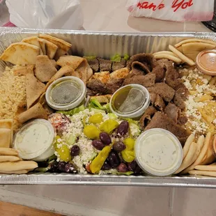 Dinner party tray.  Chicken &amp; lamb souvkaki, chicken &amp; beef/lamb gryo meat, rice, Greek fries, Greek salad,  &amp; more