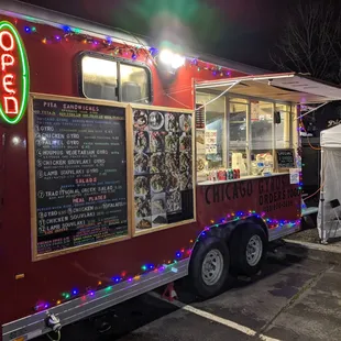 a food truck decorated with christmas lights