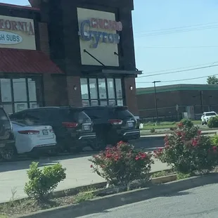 cars parked in front of a restaurant
