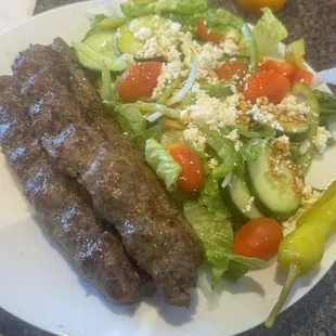 Kebab and Greek salad and fries with falafel and hummus