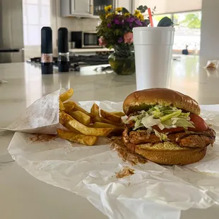 A barbeque chicken sandwich with fries