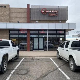 two trucks parked in front of the store