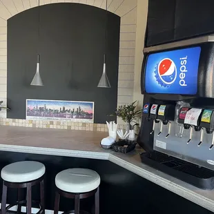 a soda machine and stools