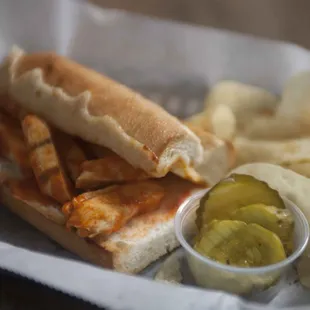 We offer a variety of sandwiches, including a Buffalo Chicken option served with chips, pickles, and ranch or blue cheese.