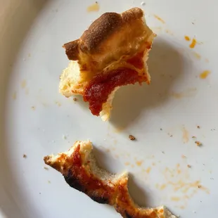 a half eaten pizza on a plate