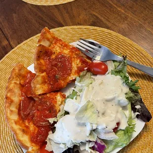 a plate of salad and a slice of pizza
