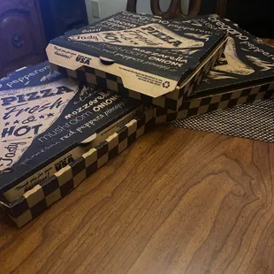 stacked pizza boxes on a table
