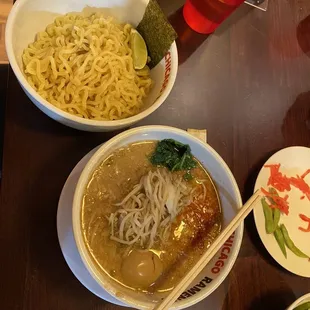 two bowls of ramen noodles with chopsticks