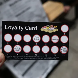 a loyalty card being held by a person