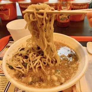 a bowl of ramen with chopsticks