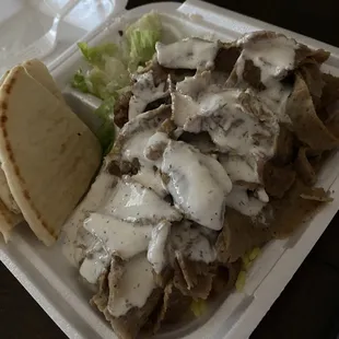 meat and gravy in a styrofoam container