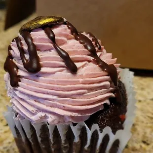 a cupcake with chocolate and pink frosting