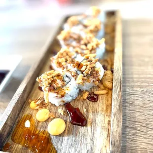 a sushi on a wooden plate