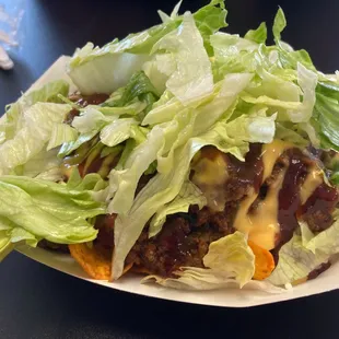 Sweet and spicy beef nachos with lettuce added.