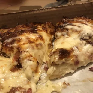 two slices of pizza in a box