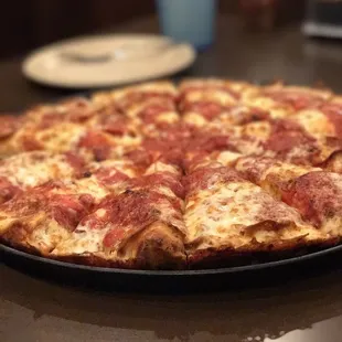a pepperoni pizza on a plate