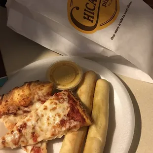 Cheese pizza, breadsticks, and nacho cheese
