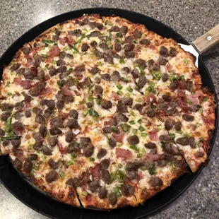 Thin n Crispy with double ground beef, ham, green pepper, and onion.