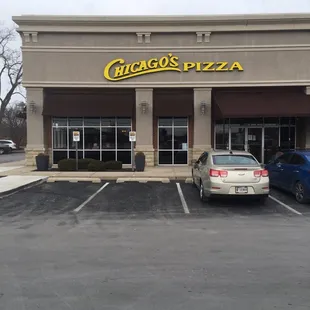two cars parked in front of a restaurant