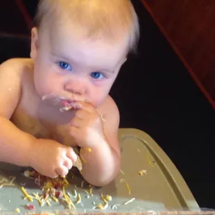 a baby in a high chair eating