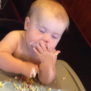 a baby eating cake