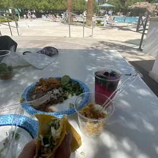 a hand holding a taco