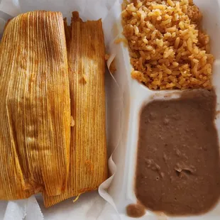 Tamales with an order of rice and beans.